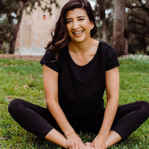 Susanna Barkataki, yoga teacher and advocate for inclusivity and authenticity, seated in Baddha Konasana (Cobbler’s Pose)