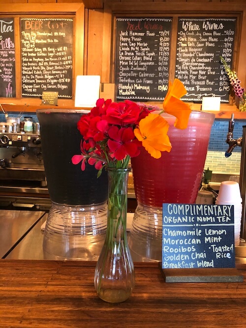 The beverage bar at Esalen, showing a menu of drinks that includes complimentary NUMI teas, a selection of wine and beer, and specialty drinks.