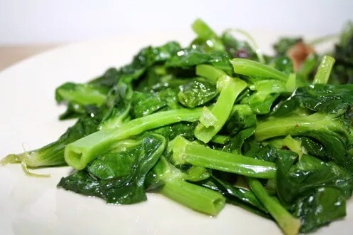 Snow pea tips, stir fried in a wok