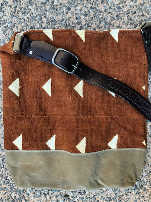 Close up of vintage belt strap and canvas bottom on Jenna Bee handmade African Mudcloth tote bags